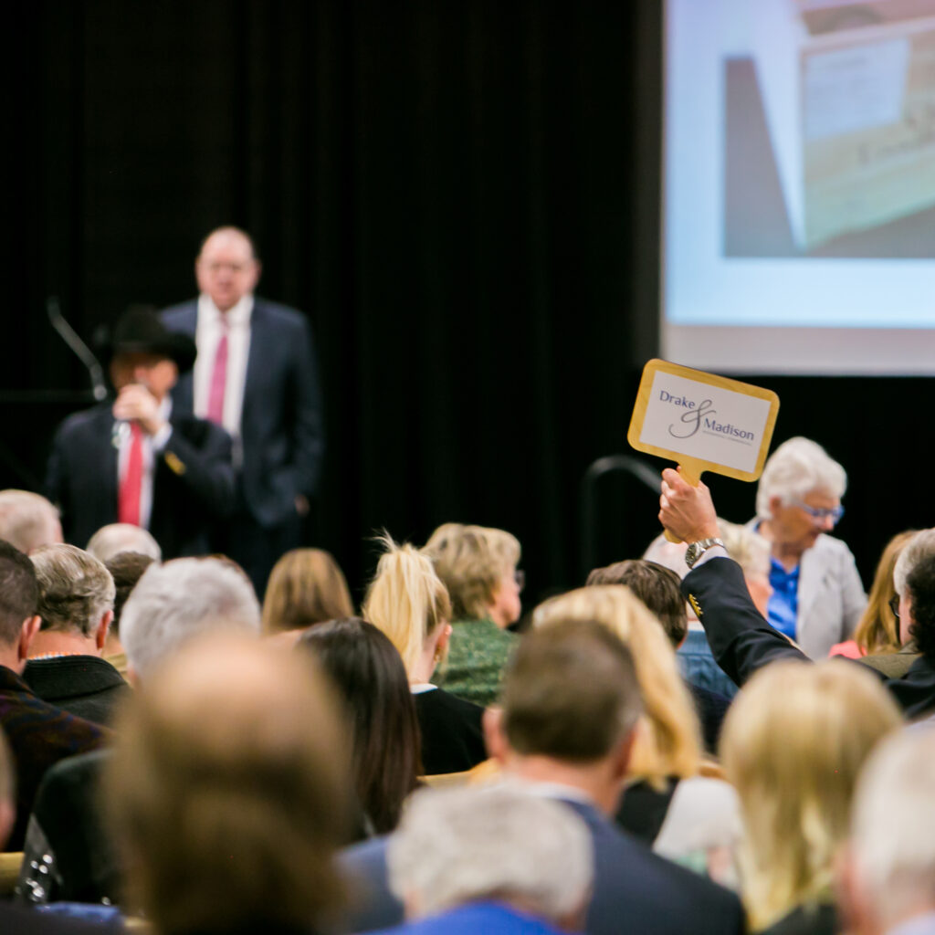 Company logo on paddle during an auction