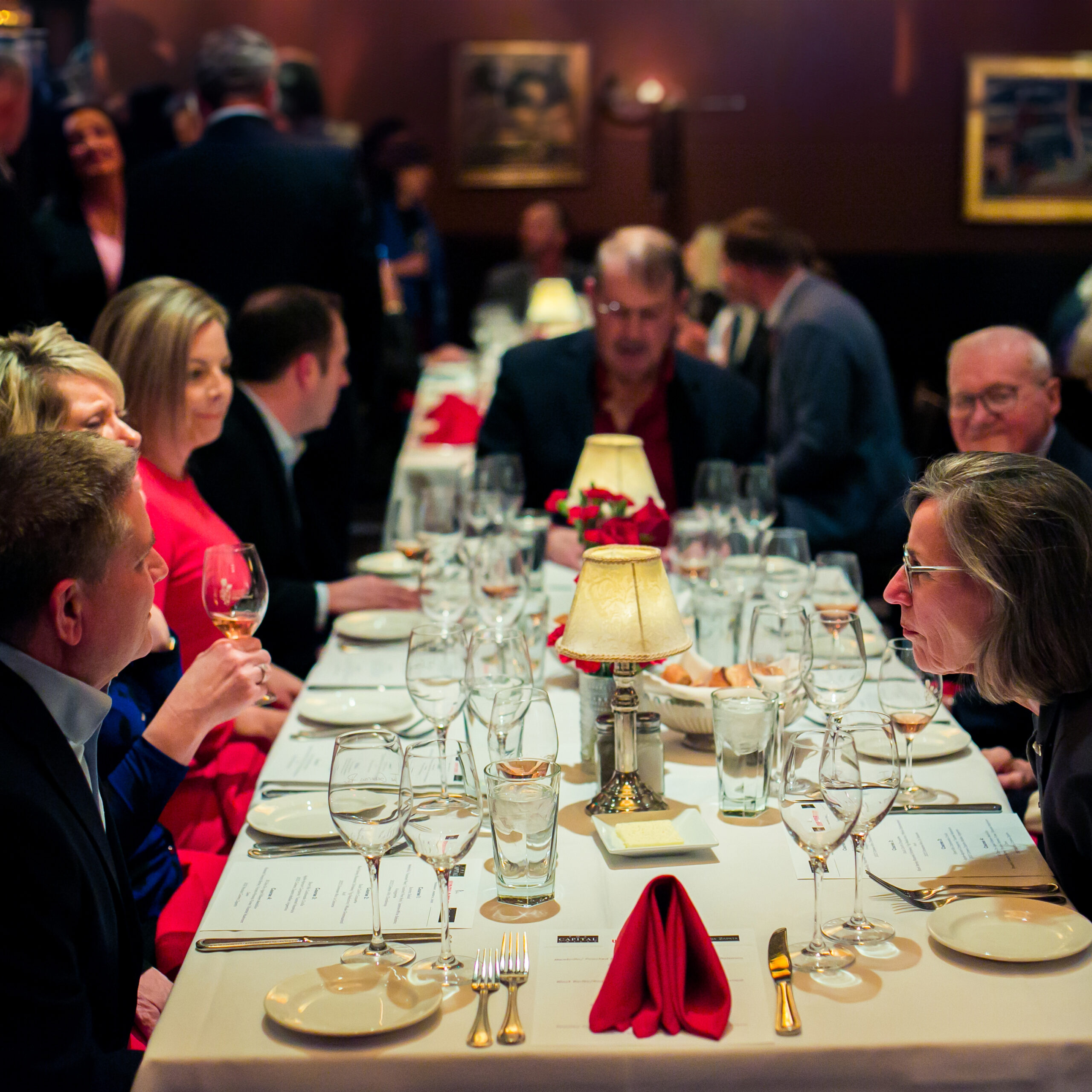 people in conversation around restaurant table