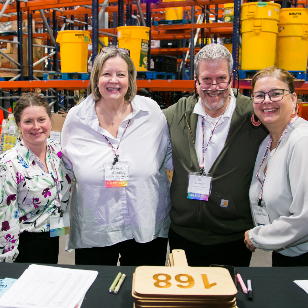 four volunteers smiling for a photo
